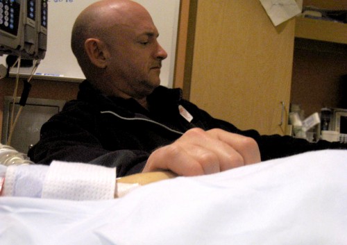 Mark Kelly, Rep. Gabrielle Giffords husband, holds her hand in Arizona